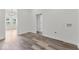 Hallway with wood-look vinyl flooring and access to laundry and other rooms at 248 N Walcott N St, Indianapolis, IN 46201