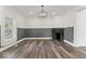 Living room features a stone fireplace and gray wood paneling at 248 N Walcott N St, Indianapolis, IN 46201