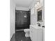Modern bathroom with dark tile shower and white vanity at 248 N Walcott N St, Indianapolis, IN 46201