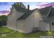 Rear view of two-story house with pink siding at dusk at 248 N Walcott N St, Indianapolis, IN 46201