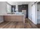 Modern kitchen with dark cabinetry, quartz countertops, and a large island at 150 S Main St # 404, Franklin, IN 46131