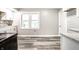 Bright kitchen with white cabinets and gray vinyl plank flooring at 534 Fletcher Ln, Beech Grove, IN 46107