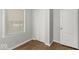 Bright bedroom with window, closet, and wood-look flooring at 3649 N Sadlier Dr, Indianapolis, IN 46226