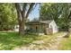 Quaint house with green porch and mature landscaping at 3649 N Sadlier Dr, Indianapolis, IN 46226