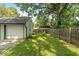 Fenced backyard with grassy area and large tree at 3649 N Sadlier Dr, Indianapolis, IN 46226