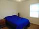 Bright bedroom with blue comforter and window at 359 N Pearl St, Thorntown, IN 46071