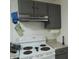 White stove and gray cabinets in a well-lit kitchen at 359 N Pearl St, Thorntown, IN 46071