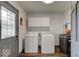 Laundry room with washer, dryer, and overhead cabinets at 17128 Towne Rd, Westfield, IN 46074