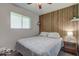 Bedroom with queen bed and wood-paneled accent wall at 17128 Towne Rd, Westfield, IN 46074
