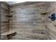 Walk-in shower with wood-look tile and built-in shelves at 17128 Towne Rd, Westfield, IN 46074