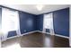 Blue bedroom with hardwood floors and two windows at 14826 Braemar E Ave, Noblesville, IN 46062