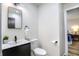 Clean bathroom with a white toilet and dark vanity at 5066 Antigua Trl, Indianapolis, IN 46237