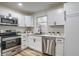 Modern kitchen with stainless steel appliances and white cabinets at 5066 Antigua Trl, Indianapolis, IN 46237