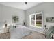 Bright bedroom with a queen bed, neutral walls, and a large window at 8807 Wintergreen Way, Indianapolis, IN 46256