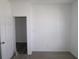 Empty bedroom with carpet, an open doorway, and multiple outlets at 10603 Maidenhair Dr, Indianapolis, IN 46239