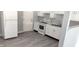 Updated kitchen with white cabinets, new flooring, and modern appliances at 3533 N Taft Ave, Indianapolis, IN 46222