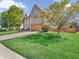 Landscaped yard with a large tree and driveway at 2249 South Lake E Ave, Greenwood, IN 46143