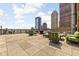 Relaxing rooftop deck with city views, featuring comfortable seating and grill at 350 N Meridian St # 901, Indianapolis, IN 46204