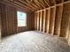 New construction bedroom with window and wood framing at 207 N Birchwood Dr, Muncie, IN 47304