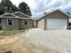 Newly built home with a two-car garage and gravel driveway at 207 N Birchwood Dr, Muncie, IN 47304