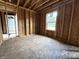 New construction bedroom with window and wood framing at 207 N Birchwood Dr, Muncie, IN 47304