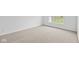 Simple carpeted bedroom with neutral walls and large window at 10601 Maidenhair Dr, Indianapolis, IN 46239