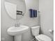 Small powder room with white pedestal sink and toilet at 9264 Hawley Dr, Indianapolis, IN 46216