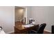 Bright home office with a desk and view into hallway at 5213 Dunewood Way, Avon, IN 46123