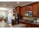 Modern kitchen with stainless steel appliances and dark wood cabinets at 5213 Dunewood Way, Avon, IN 46123