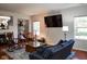 Spacious living room with large TV and comfortable seating at 5213 Dunewood Way, Avon, IN 46123