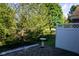 Private backyard with trees, bird bath, and white fence at 5213 Dunewood Way, Avon, IN 46123