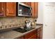 Kitchen with microwave, cooktop and wood cabinets at 5213 Dunewood Way, Avon, IN 46123