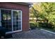 Brick patio with sliding glass door access and view of trees at 5213 Dunewood Way, Avon, IN 46123