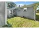 Small backyard with grassy area and brick exterior at 4013 N Graham Ave, Indianapolis, IN 46226