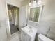 Updated bathroom with new vanity, toilet and tiled shower at 4013 N Graham Ave, Indianapolis, IN 46226