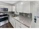Updated kitchen with stainless steel appliances and granite countertops at 4013 N Graham Ave, Indianapolis, IN 46226