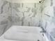 Clean bathroom featuring a bathtub and marble tile at 4013 N Graham Ave, Indianapolis, IN 46226