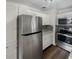 Modern kitchen with stainless steel appliances and white cabinets at 4013 N Graham Ave, Indianapolis, IN 46226