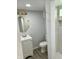 Updated bathroom with white vanity, toilet, and marble shower at 2813 Collier St, Indianapolis, IN 46241