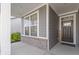 Front porch with gray door and brick accents at 17084 Cole Evans Dr, Noblesville, IN 46060