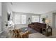 Spacious living room with a brown sectional sofa, armchair, and access to backyard at 17084 Cole Evans Dr, Noblesville, IN 46060