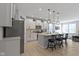 Open concept kitchen boasts white cabinets, stainless steel appliances, and an island with seating at 17084 Cole Evans Dr, Noblesville, IN 46060