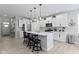 Modern kitchen features white cabinets, stainless steel appliances and an island with seating at 17084 Cole Evans Dr, Noblesville, IN 46060