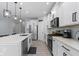 Open concept kitchen with white cabinets, stainless steel appliances, and an island at 17084 Cole Evans Dr, Noblesville, IN 46060
