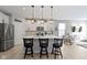 Bright kitchen with white cabinets, stainless steel appliances and an island with seating at 17084 Cole Evans Dr, Noblesville, IN 46060