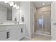 Bathroom with double vanity, large mirror, and walk-in shower at 17084 Cole Evans Dr, Noblesville, IN 46060