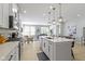 Modern kitchen features white cabinets, stainless steel appliances and an island with seating at 17084 Cole Evans Dr, Noblesville, IN 46060