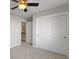 Bedroom with ceiling fan, sliding closet doors, and access to loft at 17084 Cole Evans Dr, Noblesville, IN 46060