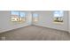 Bright bedroom with neutral carpeting and large windows offering ample natural light at 4168 Dutton Dr, Bargersville, IN 46106