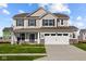 Two-story house featuring a neutral color scheme, stone accents, and a two-car garage at 4168 Dutton Dr, Bargersville, IN 46106